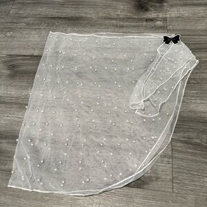 White cover up with pearls attached. See through with pieces to tie at waist.